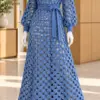 Denim blue lattice crochet dress on mannequin featuring open square grid pattern, balloon sleeves, and tied waist belt