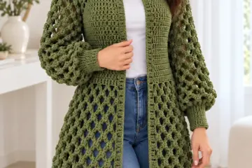 Olive green bobble lace cardigan with balloon sleeves and fitted ribbed cuffs worn over white top with jeans
