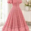 Rose pink crochet dress with V-neck, filet openwork bodice, flared skirt, and layered rose flower hem on dress form