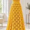 Sunflower yellow crochet maxi dress with fan lace bodice and flared skirt displayed on white mannequin